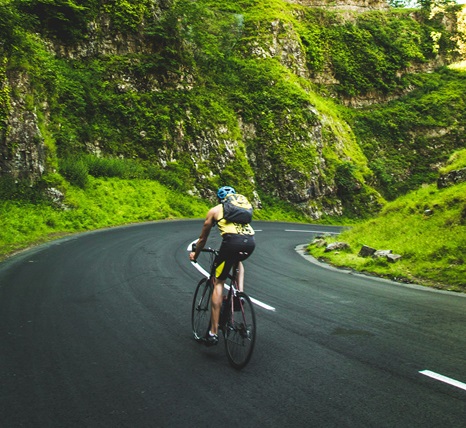 biker in the mountains turning on a winding road